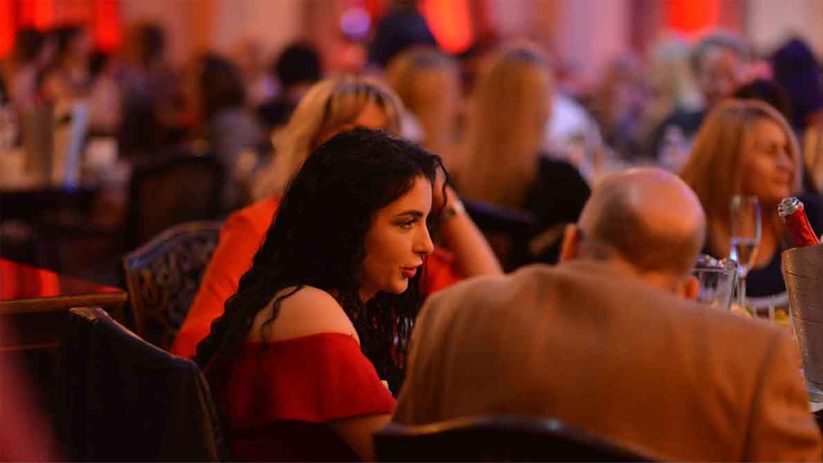 A photo of a man and woman talking at one of our socials